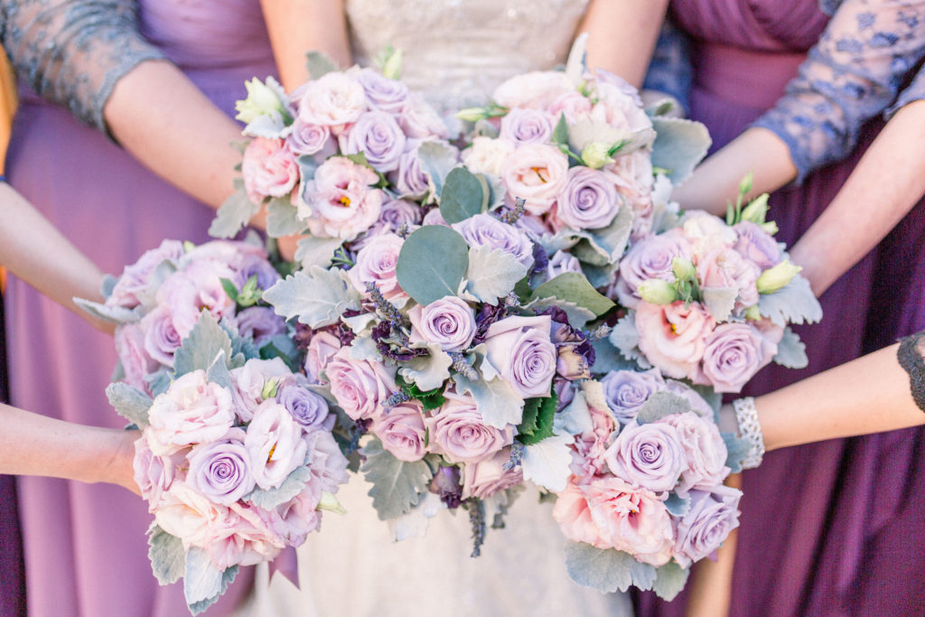 Clean and bright photography of the wedding party's floral bouquets, as all the bridesmaids and the bride hold them together. Shot at the Four Seasons at Rancho Encantado in Santa Fe, New Mexico by affordable wedding photographers in Albuquerque.