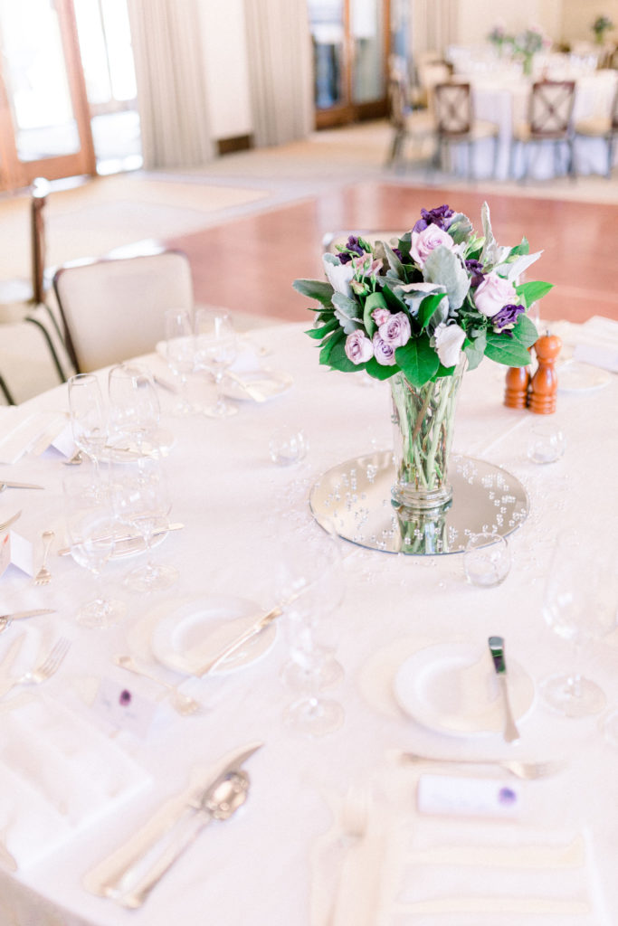 Detail shot of the wedding floral arrangements in purple and white, displayed on the tables at Four Seasons in Santa Fe, New Mexico for a local engaged couple's wedding shot by local wedding photographers, Shayla Cristine Photography.