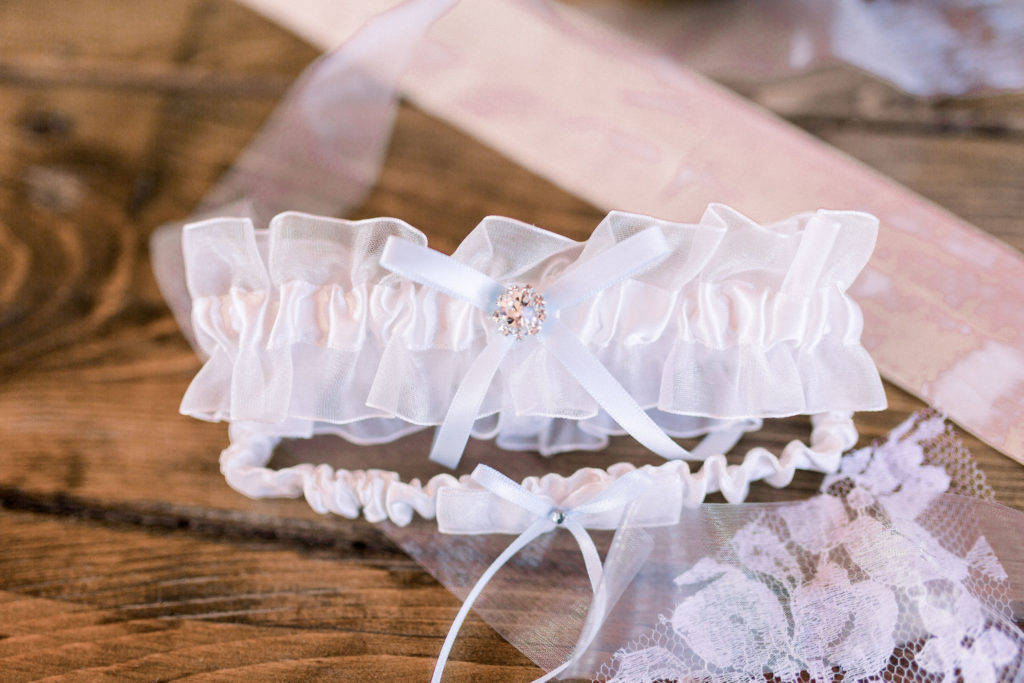 Detail shot of the local bride's garter belt and wedding gown details, jewelry, for a local wedding at the Four Season Rancho Encantado, shot by Shayla Cristine Photography, Albuquerque wedding photographers.