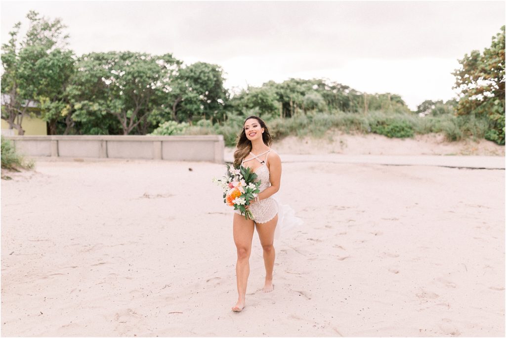 Lais DeLeon struts across the sand to join her soon to be husband, Beau Hightower, who is waiting to marry her on the beach with their adventure wedding photographer, Shayla Cristine Photography, right beside them to capture every moment. 