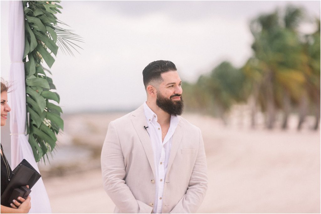 The handsome groom waiting in the sand for his bride. Dr. Beau Hightower and Lais DeLeon had a beach wedding with a gorgeous arch - captured by Shayla Cristine Photography, an adventure photographer in Albuquerque, New Mexico who specializes in bright and airy wedding photography.