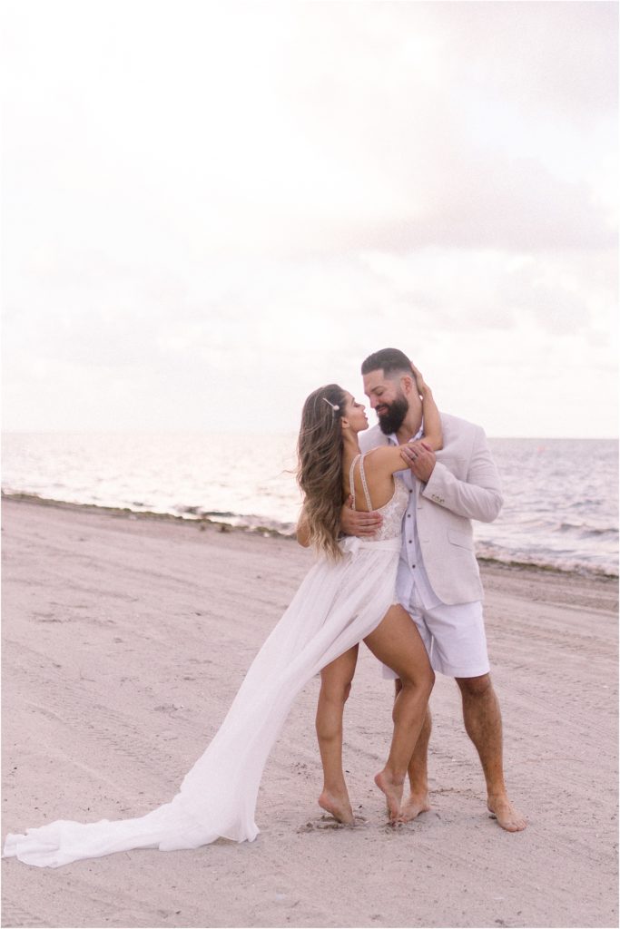 The beautiful couple, Dr. Beau Hightower and Lais DeLeon, enjoying a special moment on the beach after their wedding elopement with Shayla Cristine Photography, a New Mexico based adventure wedding photographer who travels.