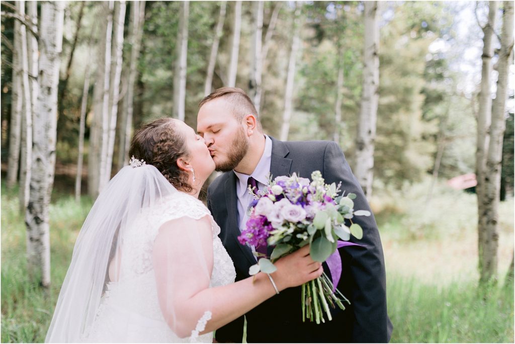 The happy bride and gorgeous groom share a sweet kiss before their wedding ceremony, captured by New Mexico's best wedding photographer Shayla Cristine Photography.